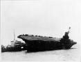 HMS Ark Royal listing heavily taking off survivors