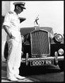 Twiss inspecting number plate of car 0007 RN c. 1967.