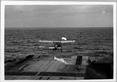 Aircraft operating from HMS Ark Royal: plane taking off showing steam