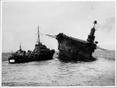 HMS Ark Royal showing lowering of survivors onto destroyers